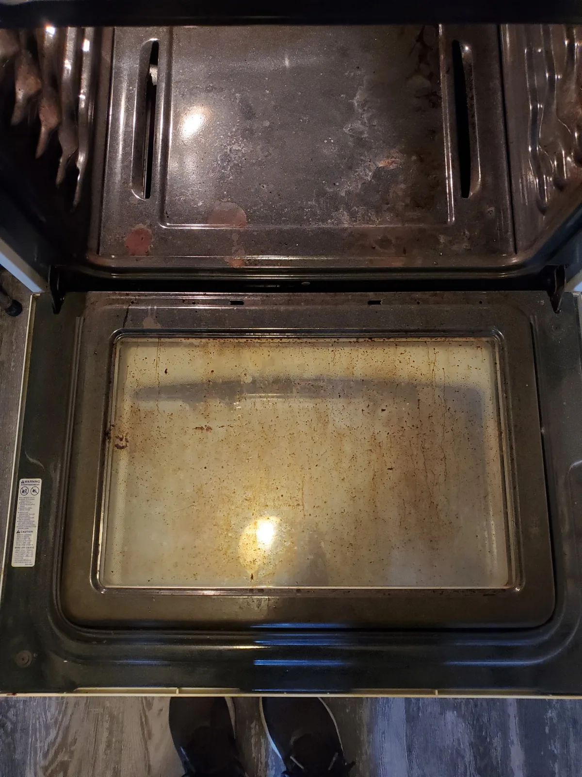 Dirty oven before deep cleaning with greasy interior