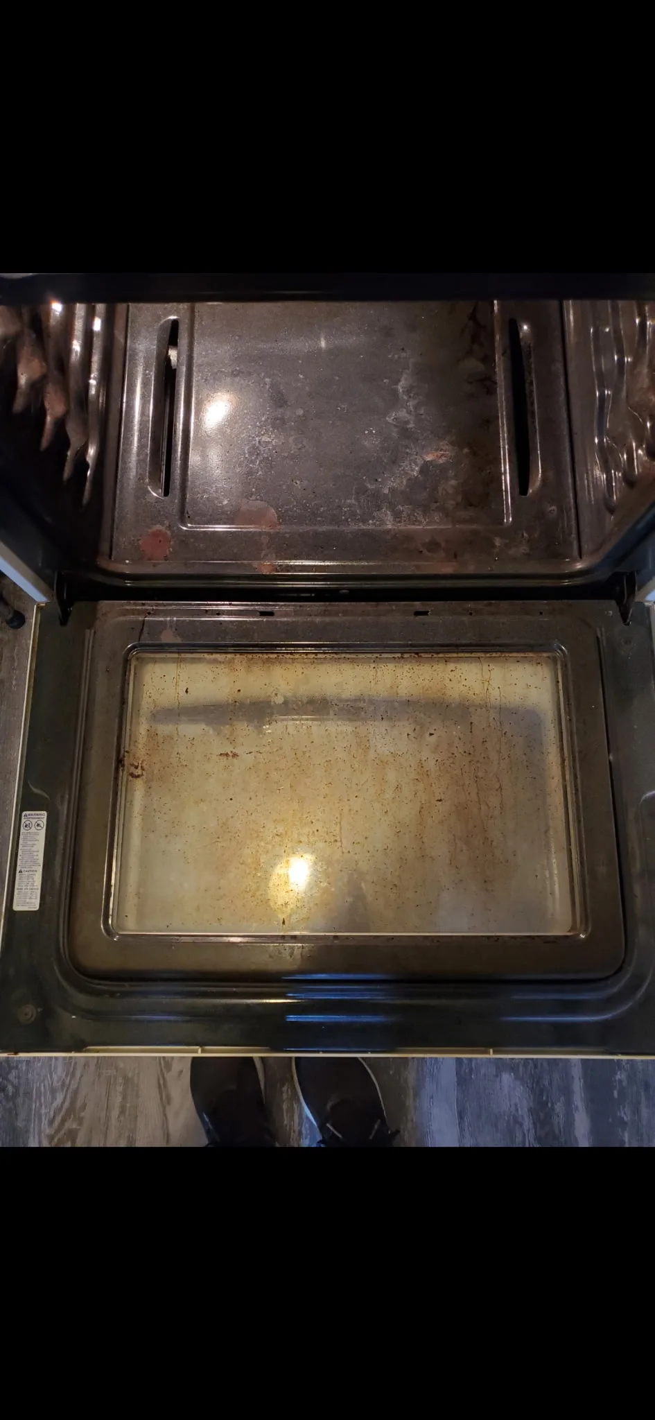 Greasy oven door before cleaning