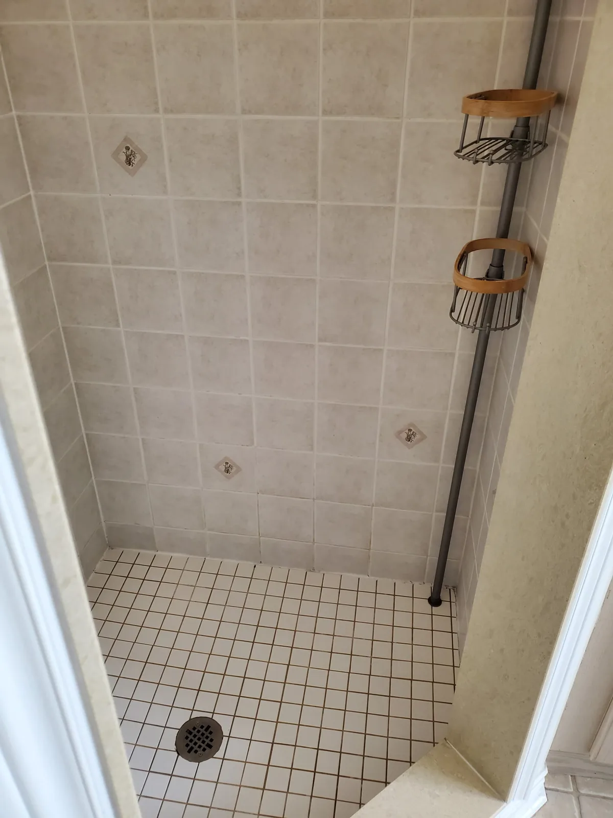 Clean shower floor with white grout after deep cleaning