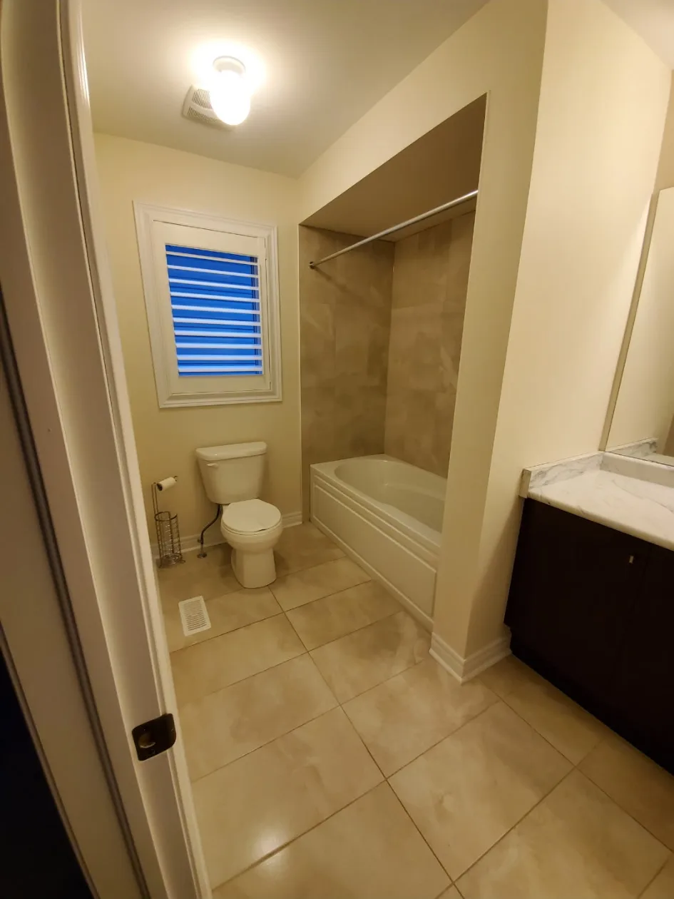 Fully cleaned bathroom with toilet tub and vanity