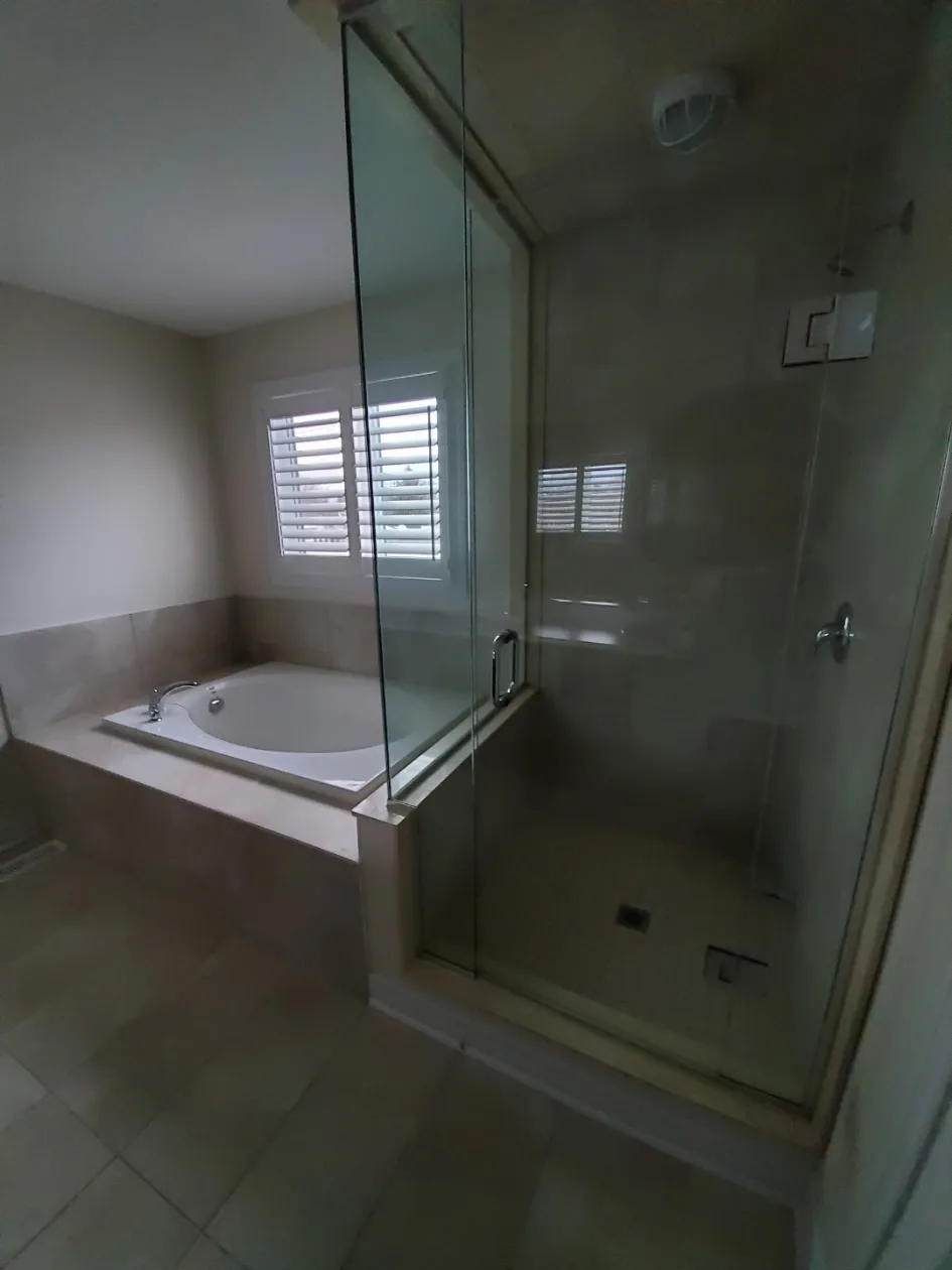 Clean master bathroom with soaker tub and glass shower