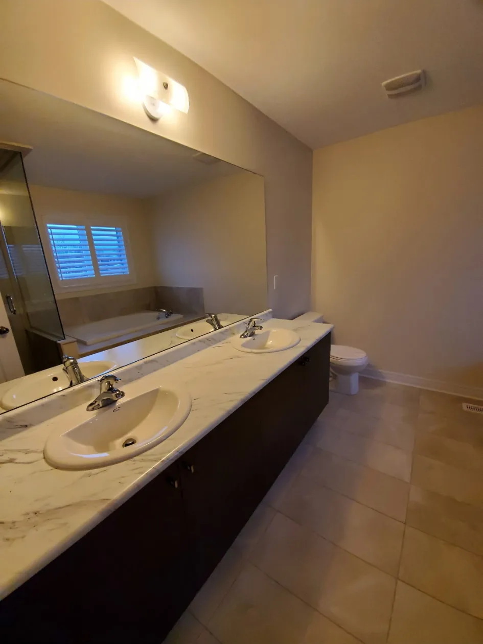 Clean master bathroom with double sink vanity